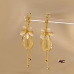 Pendientes con borlas de flores y piedra de ojo de gato